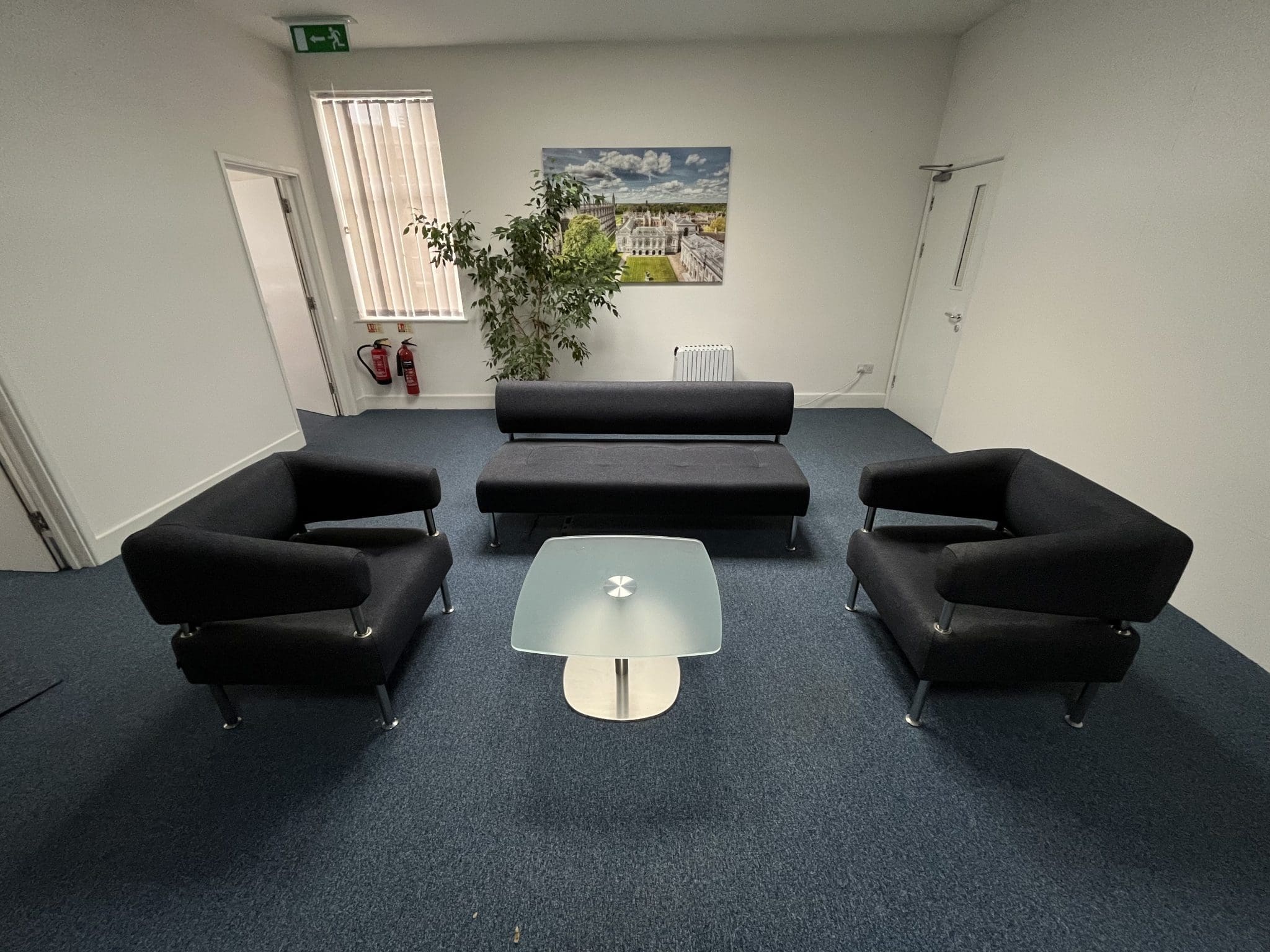Black sofa chairs with glass coffee table